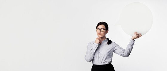 Business Thoughts. Businesswoman Thinking Holding Empty Speech Bubble Touching Chin Over White...
