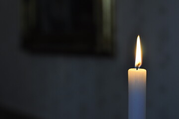 Candlelight peacefully burning in the dark night. Candles can be used for decoration, holiday-events, romance and ceremonies.
