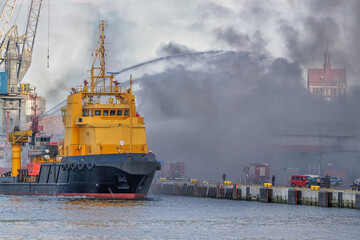 A fire in a warehouse in which a toy wholesaler caught fire. The fire was extinguished by firefighting vessels and fire brigade units, Port of Gdansk, Gdansk, Poland. date of destruction July 14, 2024