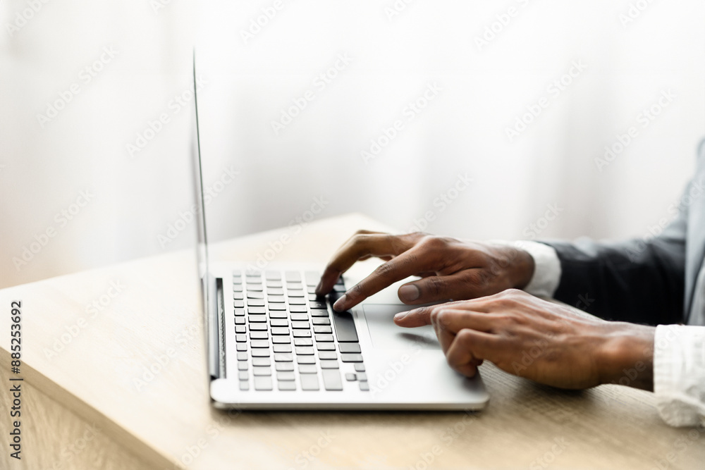 Aufkleber a person types on a laptop computer at a desk.