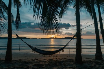 Serene beach sunset with hammock and palm trees
