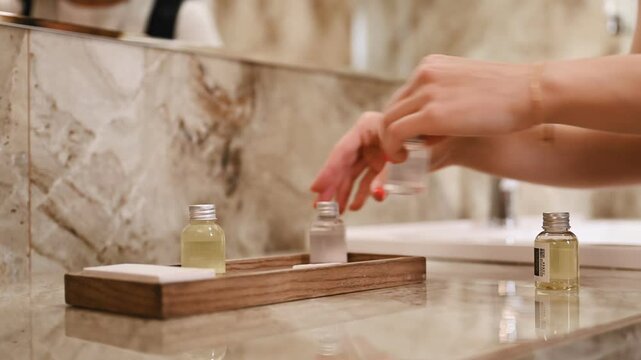 Bathroom cleaning. Young chambermaid is in hotel room.