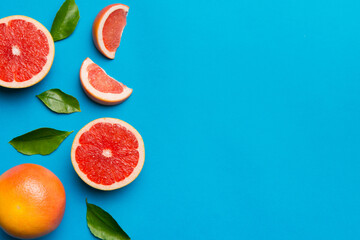 fresh Fruit grapefruit with Juicy grapefruit slices on colored background. Top view. Copy Space. creative summer concept. Half of citrus in minimal flat lay with copy space