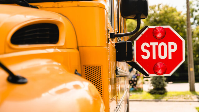 Yellow school bus. Stop sign. Be careful, schoolchildren crossing the road. New academic year semester. Welcome back to school. Lockdown, distance remote education learning - Powered by Adobe