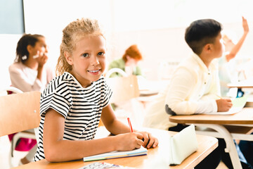 Caucasian young smart schoolgirl pupil student attending school lesson class listening to the teacher. Back to school. New academic year semester.