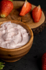 yogurt made from milk with added flavor and pieces of ripe strawberries