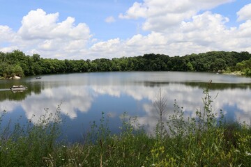 The peaceful lake in the countryside on a cloudy sunny day.