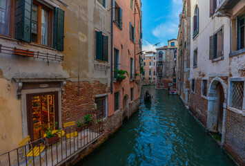 Venice, Italy - June 03, 2024: Gondola Glide Through Venice. Cure shop balcony on the foreground.