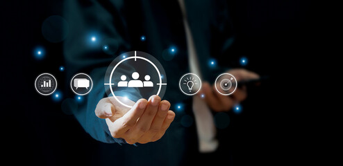 Business marketing position concept, businessman holds dart board icon with arrows for customer target group.