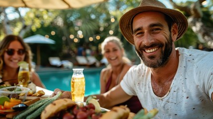 A group of friends enjoying food and drinks by the poolside under an umbrella, with everyone smiling and relaxed, surrounded by various delicious dishes and beverages.