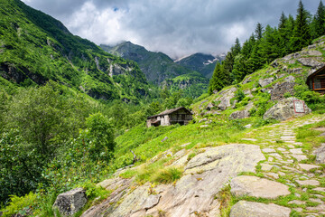 Panorama of the valley of Sesia, at the slopes of the peaks of Northern Italy Alps (Monte Rosa Massif, the 2nd highest mountain of Europe), during early summer.