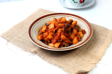 Sambal Goreng Ati Kentang, javanese (Indonesia) traditional food. Served in plate. Copy space.fried potatoes cooked with chili and chickens liver