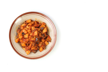 Sambal Goreng Ati Kentang, javanese (Indonesia) traditional food. Served in plate. Copy space.fried potatoes cooked with chili and chickens liver