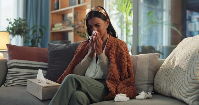 Home, sick and woman with cold, tissue and influenza symptoms in lounge, sinusitis disease and virus. Person, apartment and girl on couch, winter health problem and allergy with blanket and hayfever