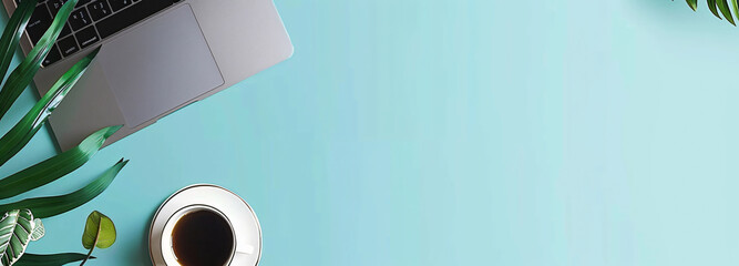 Minimalist blue background for product presentation with office desk, laptop and coffee cup in a flat lay top view copy space.