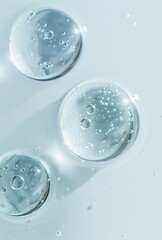 Close-up of transparent gel bubbles on light blue surface