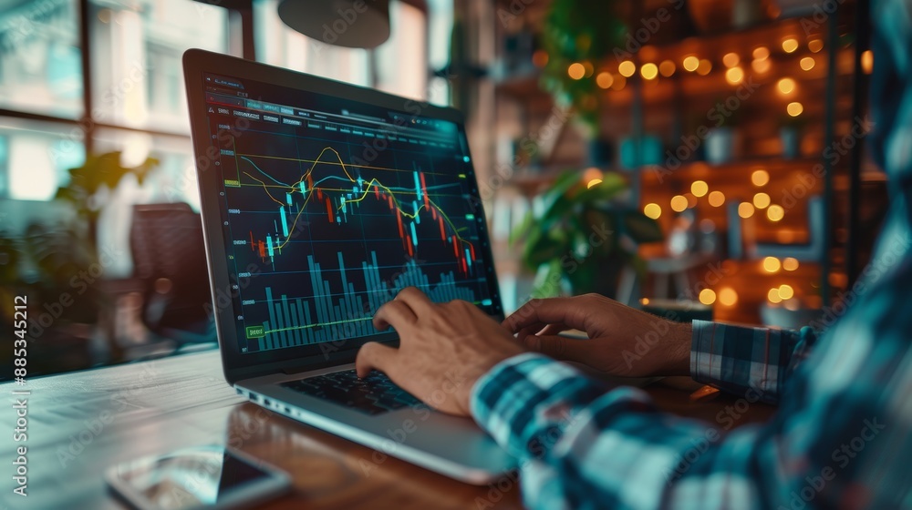 Poster analysis of data to boost sales and revenue. a man sits in front of a laptop and works on a growing 