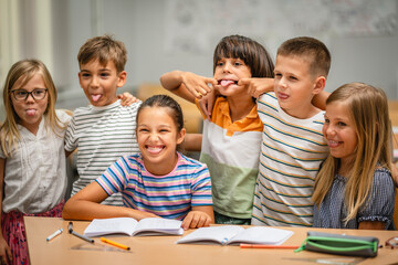 Fototapeta na wymiar Portrait of group young students climb and have fun in the classroom