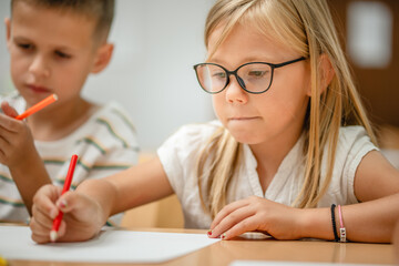 Young girl students paint and draw on class in the classroom