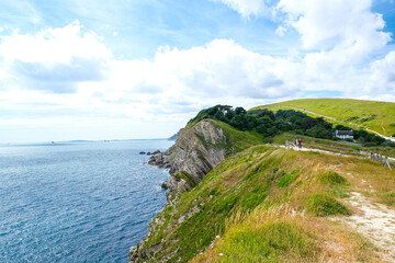 Jurassic coast view in Dorset near Lulworth Cove. Lulworth Cove cliffs view on a way to Durdle Door. The Jurassic Coast is a World Heritage Site on the English Channel coast of southern England.Dorset