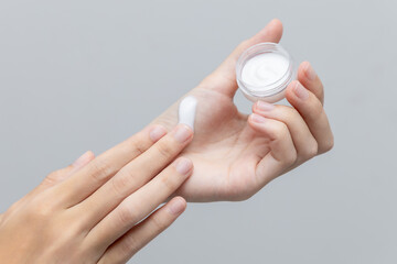 Woman applying hand cream