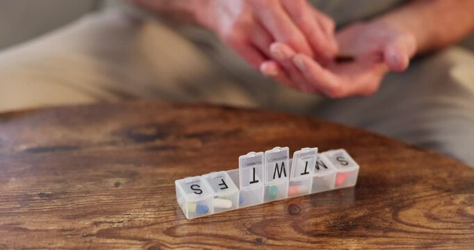 Hands, medication and person with pills for week in container for medical treatment on desk. Medicine, vitamins and closeup of patient separate supplements or tablets in box for healthcare at home.