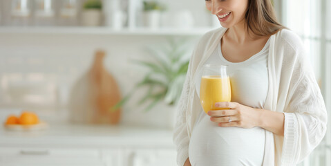 Pregnant woman enjoying a healthy glass of orange juice in a bright kitchen, emphasizing health, nutrition, and well-being during pregnancy.