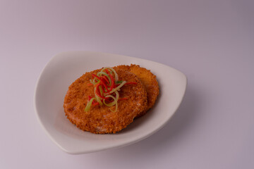 fried spam coated with bread crumb on a white background