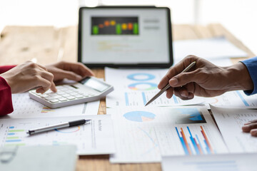 Business consulting meeting is discussing analysis financial data and business growth charts to plan strategy for generating company profits. Discuss cost budget analysis and plan to increase profits.