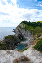 Jurassic coast view in Dorset, England, UK. Stair Hole near Lulworth Cove. Lulworth Cove cliffs view on a way to Durdle Door. The Jurassic Coast is a World Heritage Site on the English Channel coast 