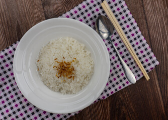 bowl of rice with chopsticks and spoon