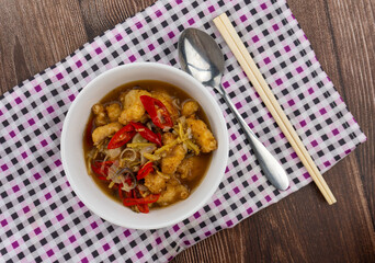 top view shot of ginger chicken with spoon and chopstick on the side