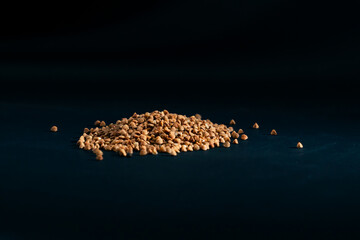 buckwheat lies on a black and blue background Ukrainian culture light protein food vegetarianism...