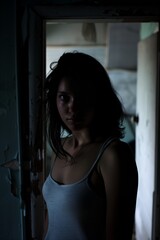 Fototapeta premium Distressed woman in shadowed doorway