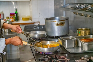 Cooking in a restaurant kitchen on a gas stove 