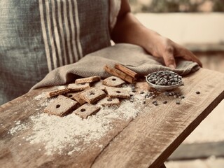 The baker with freshly baked biscuits.
