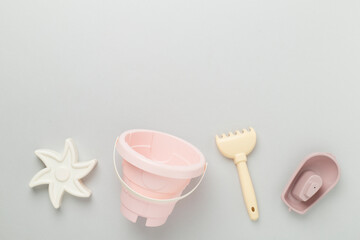 Cute toys for playing with sand on color background, top view
