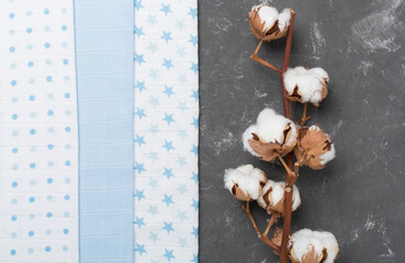 Cotton fabric with branch on concrete background, top view