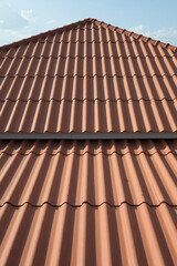 Roof is covered with red double wavy tiles.