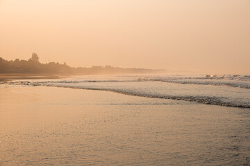 Ocean landscape with humid and misty air during heat wave, shot at sunset time. La Libertad beach, El Salvador, Central America.