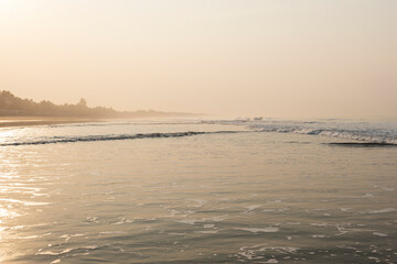 Ocean landscape with humid and misty air during heat wave, shot at sunset time. La Libertad beach, El Salvador, Central America.