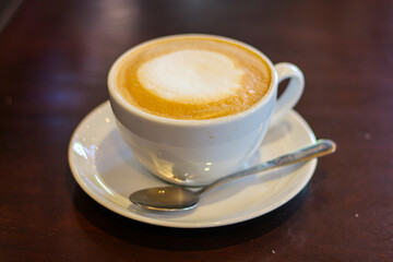 Latte hot coffee ready for drink put on table.