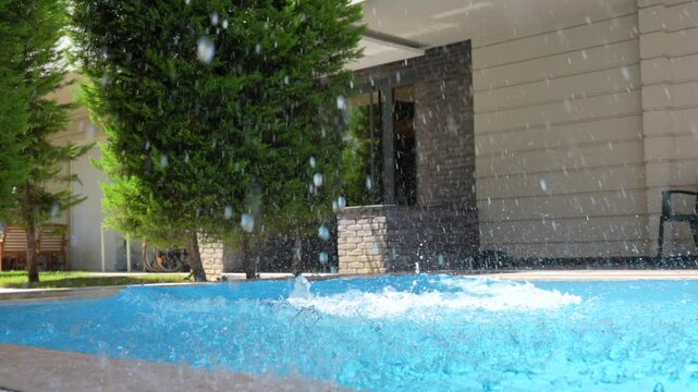 Young woman jumping in the pool.