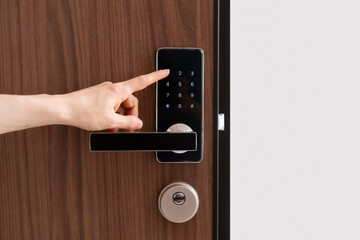 Person entering password code on digital door lock