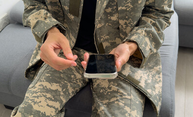 Soldier using a mobile phone against white background