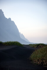 Stunning view of Vestrahorn at sunset with some black sand dunes in the foreground. Vestrahorn is...