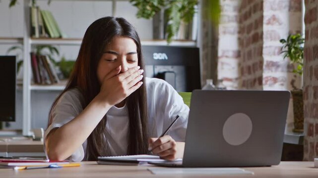Boring distance learning. Asian student girl yawning, falling asleep while watching webinar on laptop