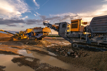 Heavy and mobile machinery in a quarry to transform stone into construction material