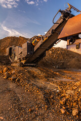 Heavy and mobile machinery in a quarry to transform stone into construction material