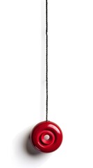 Vibrant Red Yo Yo Suspended on Black String Against Plain White Background